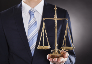 Businessman Holding Justice Scale